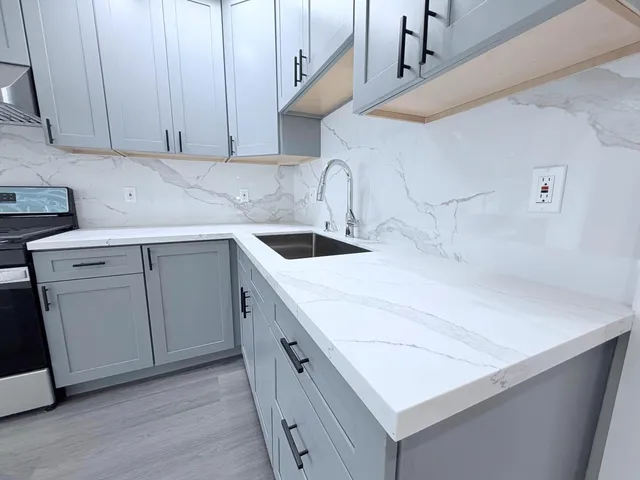 a kitchen with a sink and cabinets