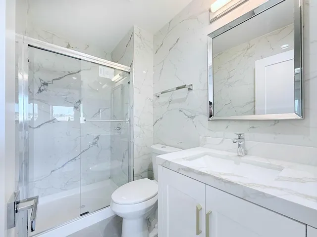 a bathroom with a sink toilet and shower