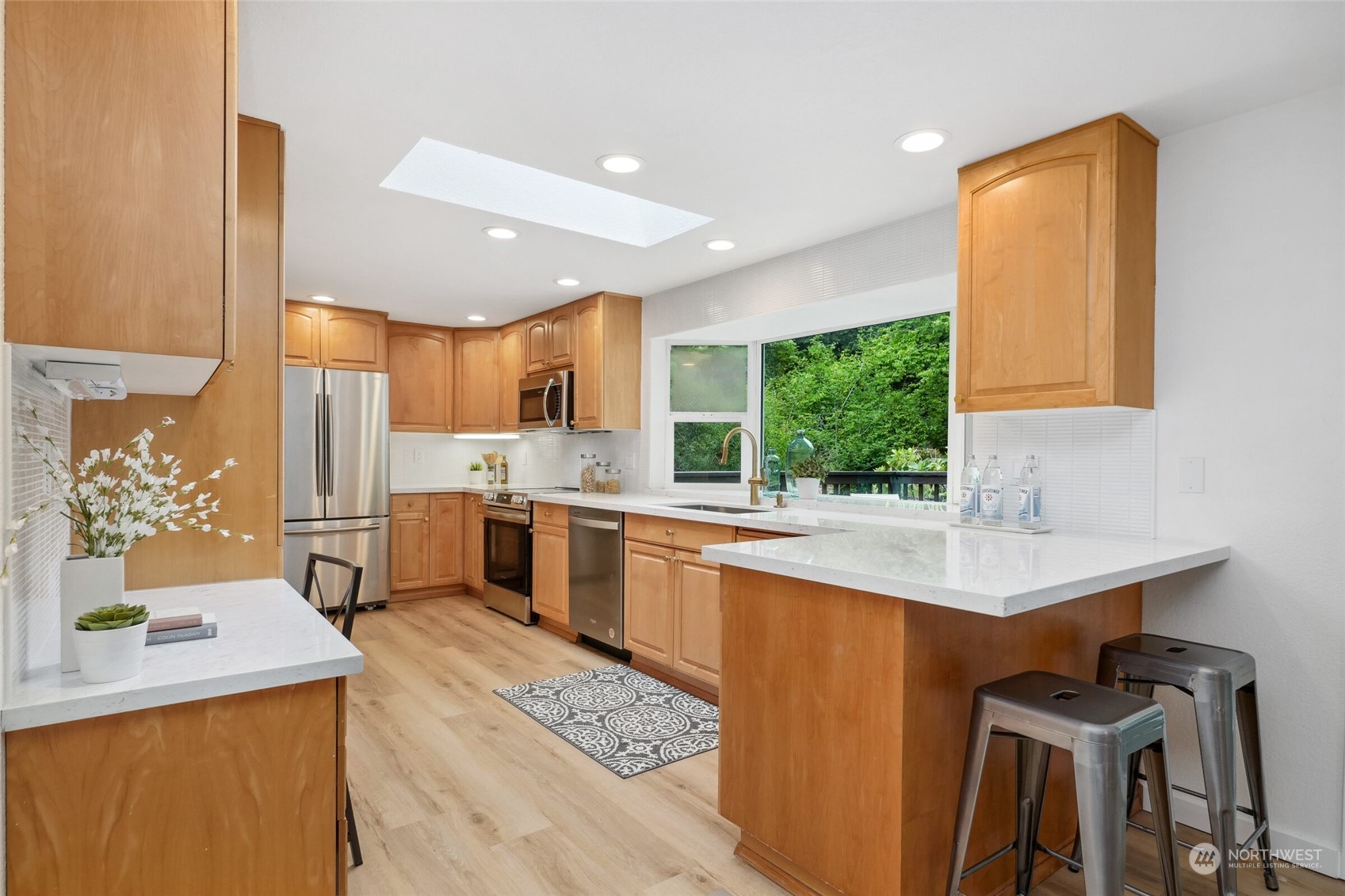 24113 10th Place West Bothell, WA 98021 - Photo 13 of 35 a kitchen with a sink a counter top space stainless steel appliances and a window