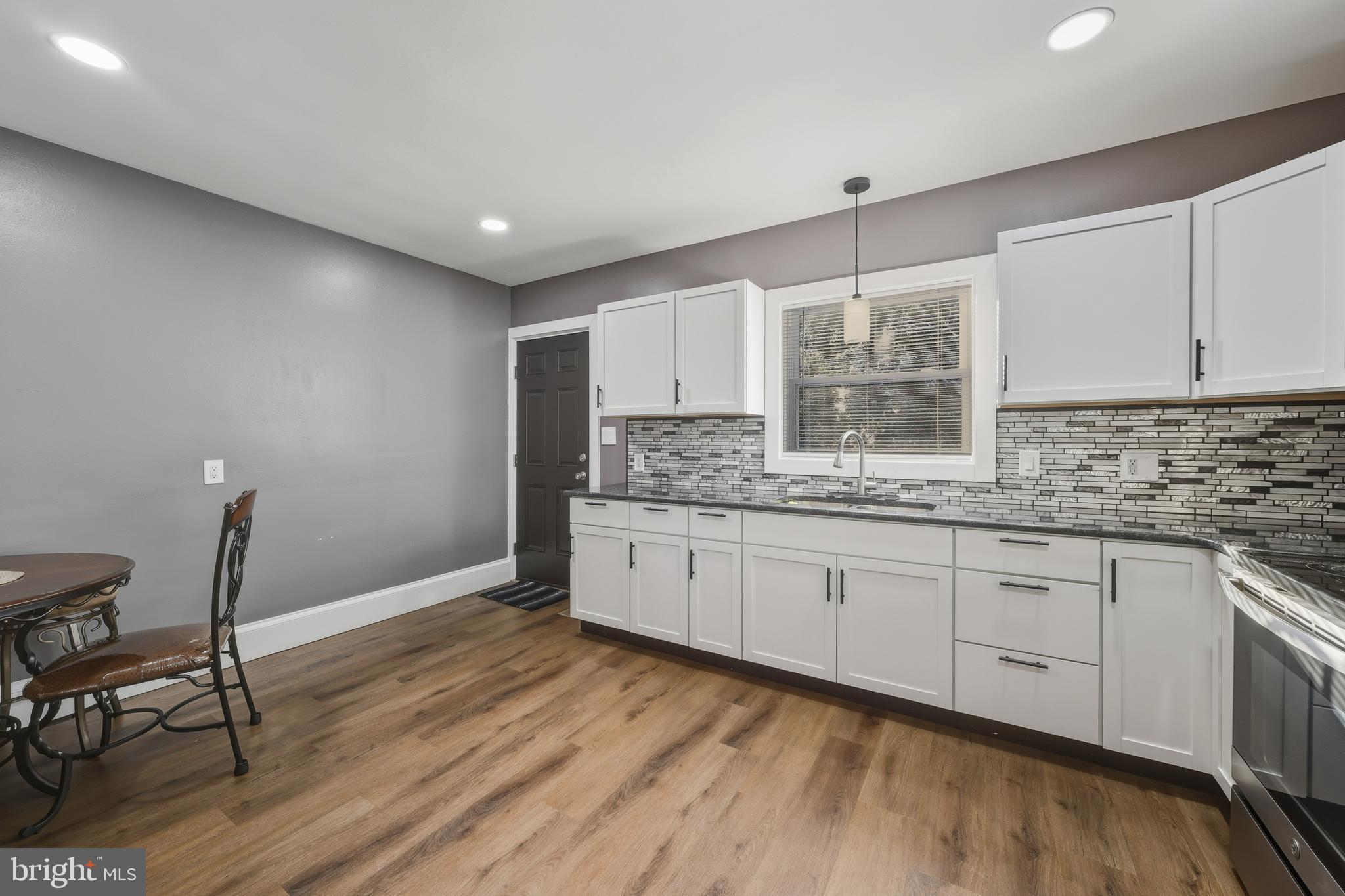 114 Magnolia Avenue Bridgeton, NJ 08302 - Photo 11 of 30 a kitchen with granite countertop white cabinets and white appliances