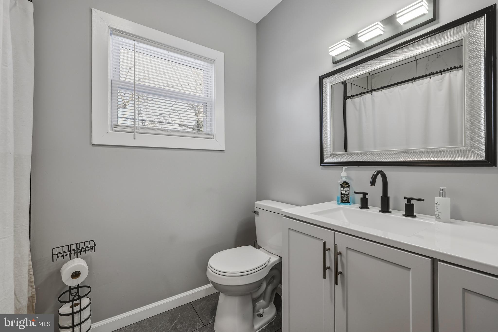 114 Magnolia Avenue Bridgeton, NJ 08302 - Photo 17 of 30 a bathroom with a toilet sink vanity and mirror