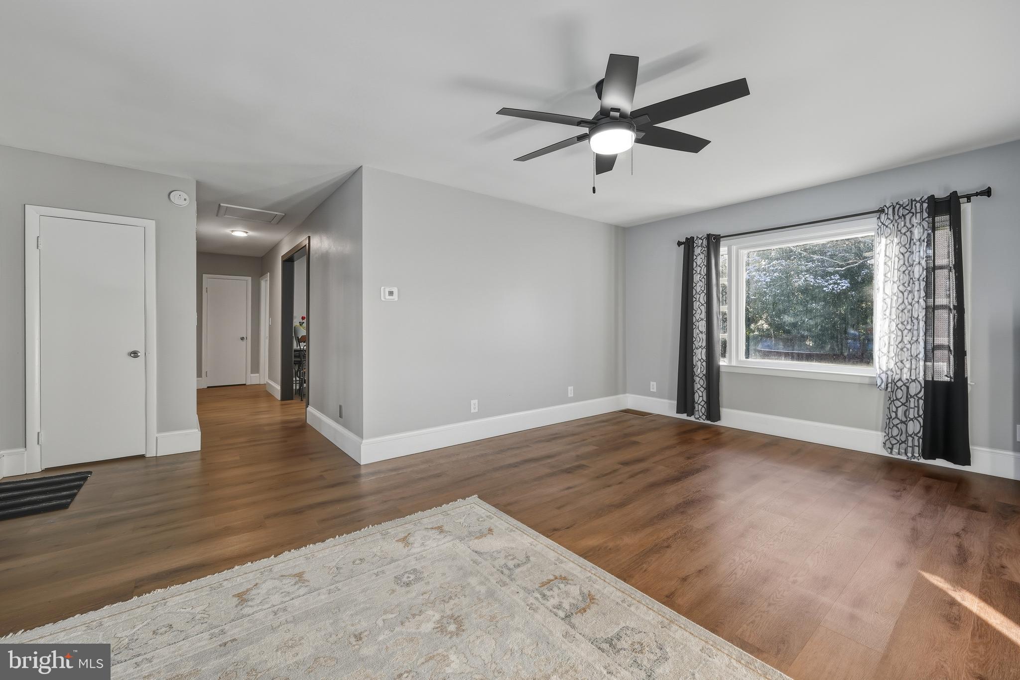 114 Magnolia Avenue Bridgeton, NJ 08302 - Photo 5 of 30 a view of an empty room with wooden floor and a window