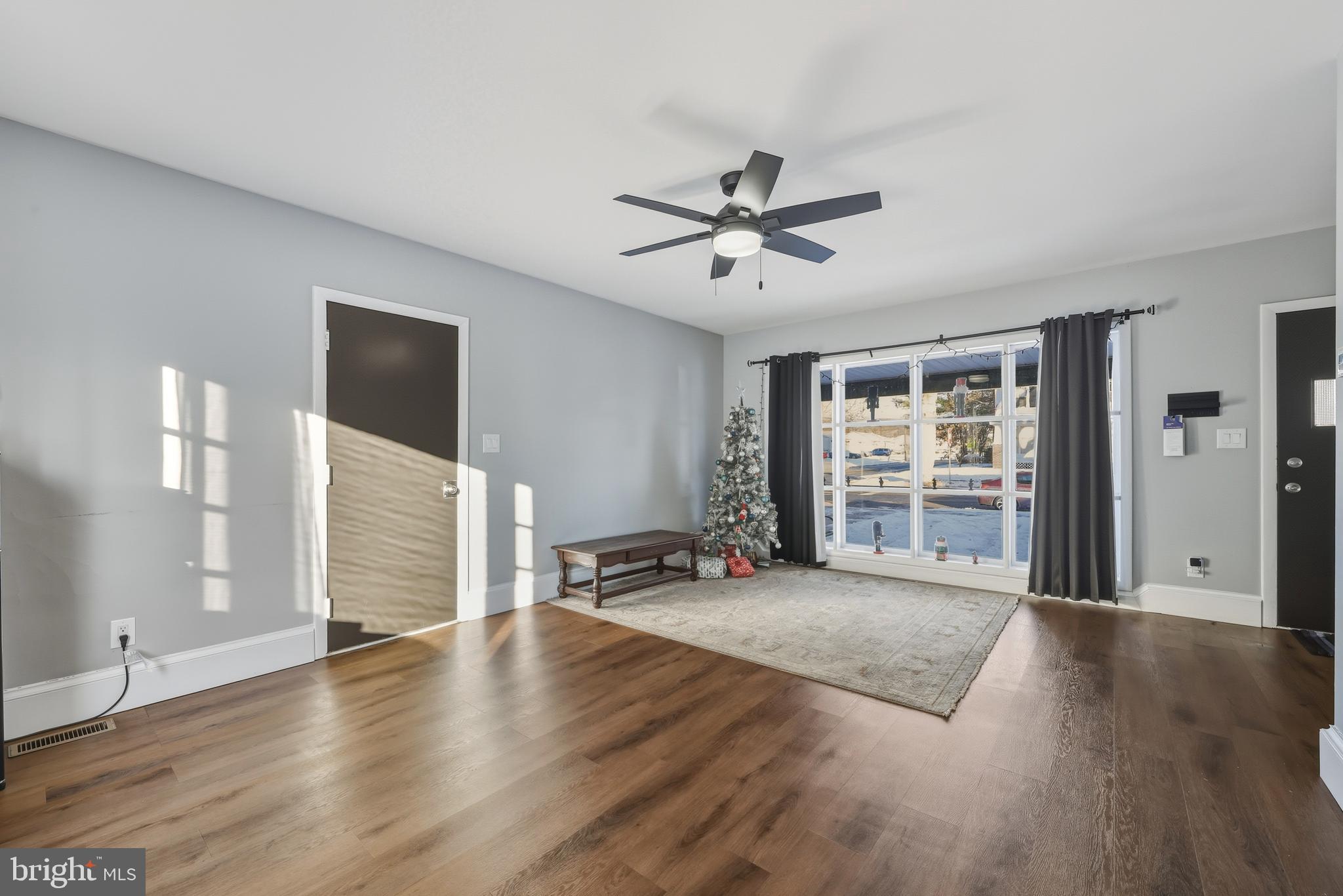 114 Magnolia Avenue Bridgeton, NJ 08302 - Photo 6 of 30 a view of an empty room with a window and wooden floor
