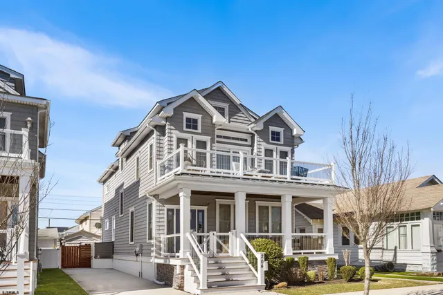 a front view of a residential apartment building with a yard