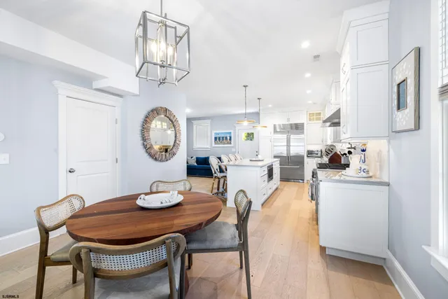 a kitchen with stainless steel appliances kitchen island granite countertop a stove a sink and a refrigerator