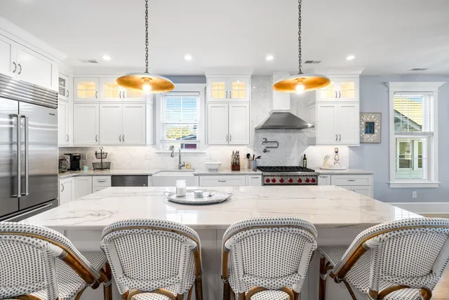 a kitchen that has a lot of cabinets in it and wooden floors