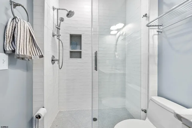 a view of staircase with lots of frames on wall and wooden floor