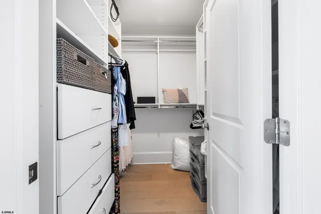 a spacious bedroom with a bed couch and a window