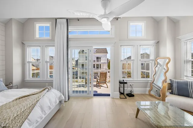 a spacious bedroom with a bed a couch and dresser