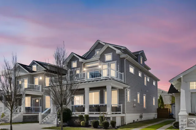 a front view of a building with lot of cars
