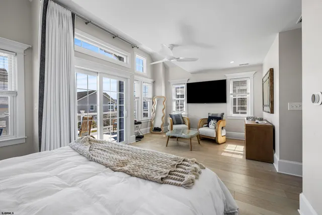 a living room with furniture a flat screen tv and a window
