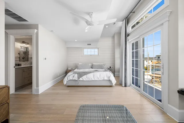 a bathroom with a double vanity sink toilet mirror and shower