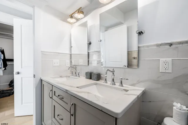 a bathroom with a sink double vanity and a mirror