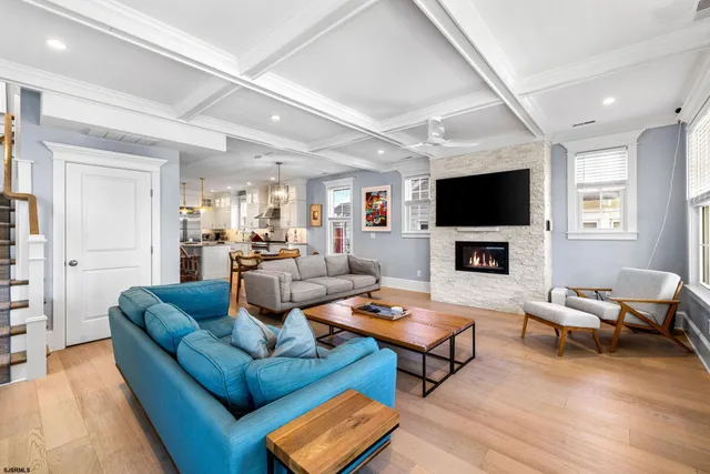 a living room with furniture a rug and a flat screen tv