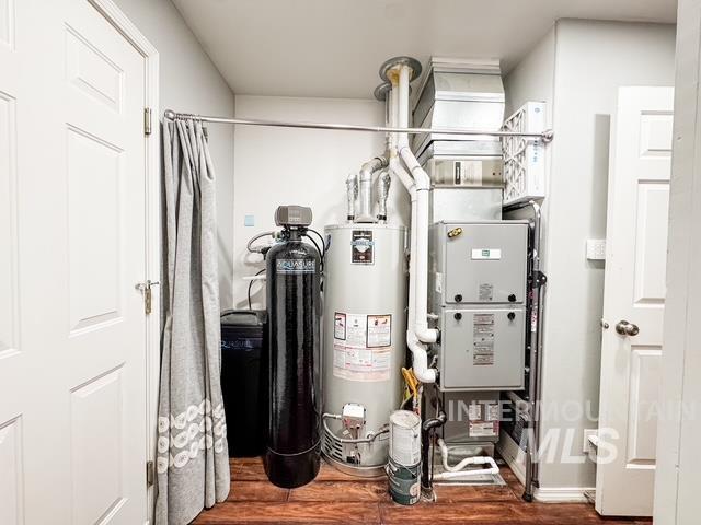 808 O'Leary Way Twin Falls, ID 83301 - Photo 27 of 37 Utility area featuring a water heater, water softener, and HVAC system with exposed ductwork, all set on wood-finish flooring