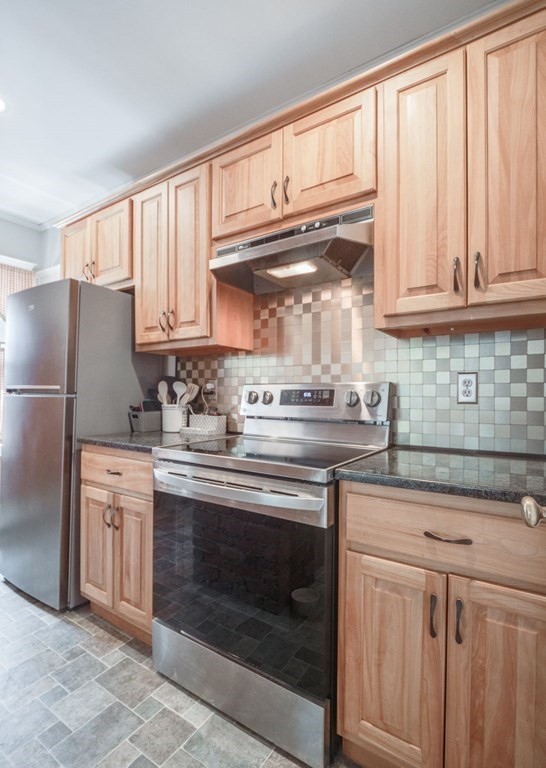 81 Baker Street Boston, MA 02132 - Photo 12 of 42 a kitchen with stainless steel appliances granite countertop a sink and cabinets