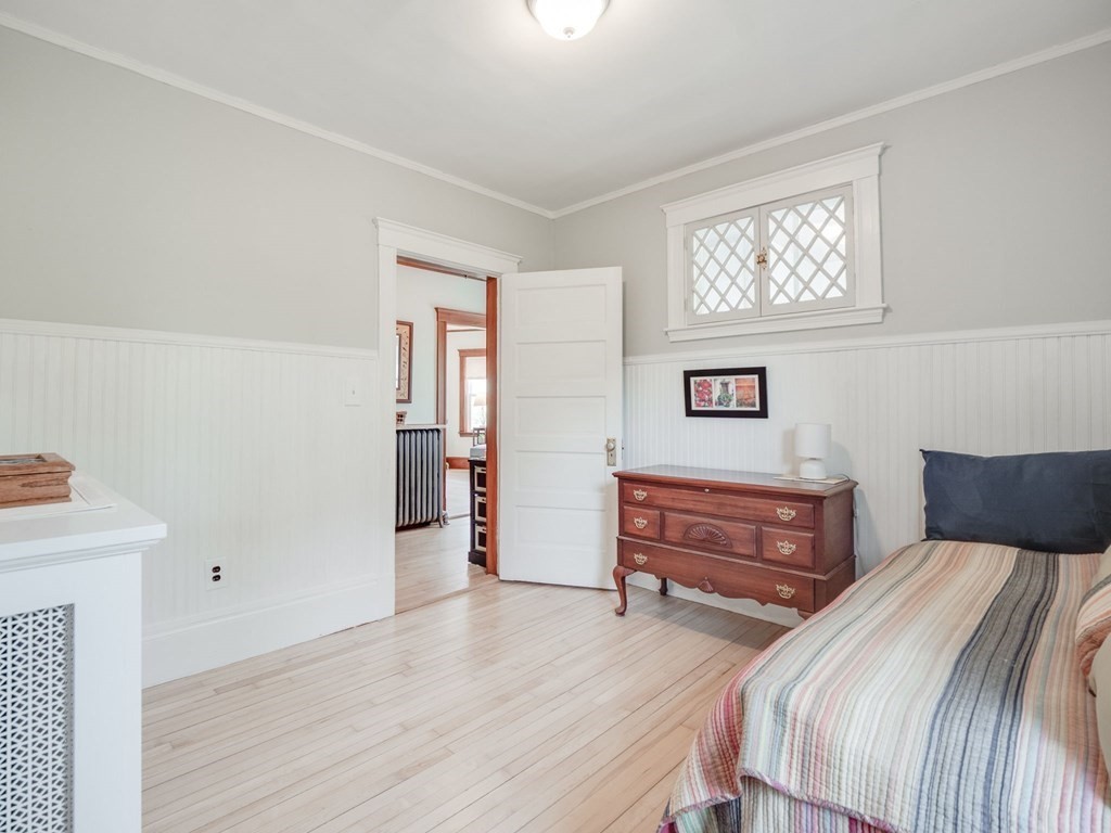 81 Baker Street Boston, MA 02132 - Photo 23 of 42 a bedroom with a bed and a dresser