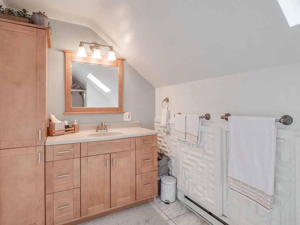 81 Baker Street Boston, MA 02132 - Photo 30 of 42 a bathroom with a double vanity sink a toilet and a mirror