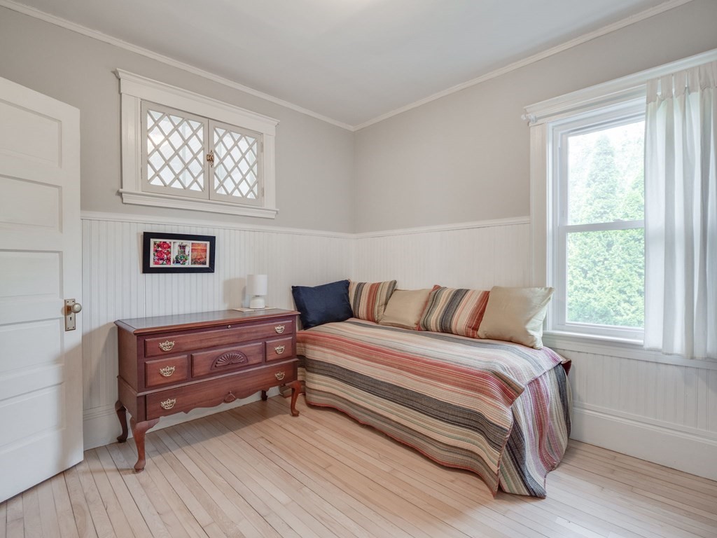 81 Baker Street Boston, MA 02132 - Photo 32 of 42 a bed sitting in a bedroom next to a window