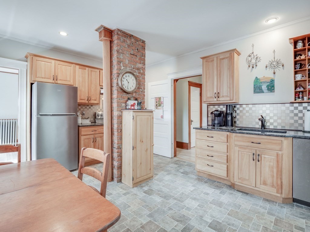 81 Baker Street Boston, MA 02132 - Photo 8 of 42 a kitchen with stainless steel appliances a refrigerator sink and cabinets