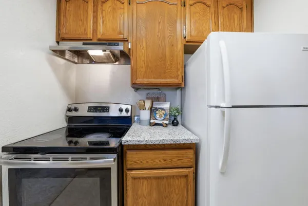 a kitchen with stainless steel appliances granite countertop a stove and a refrigerator