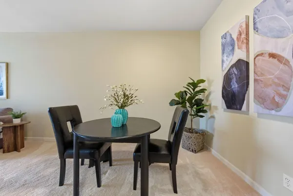 a dining room with furniture and wooden floor