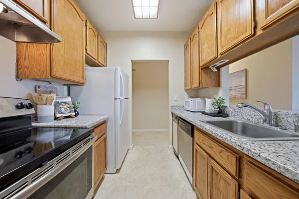a kitchen with a sink and a refrigerator