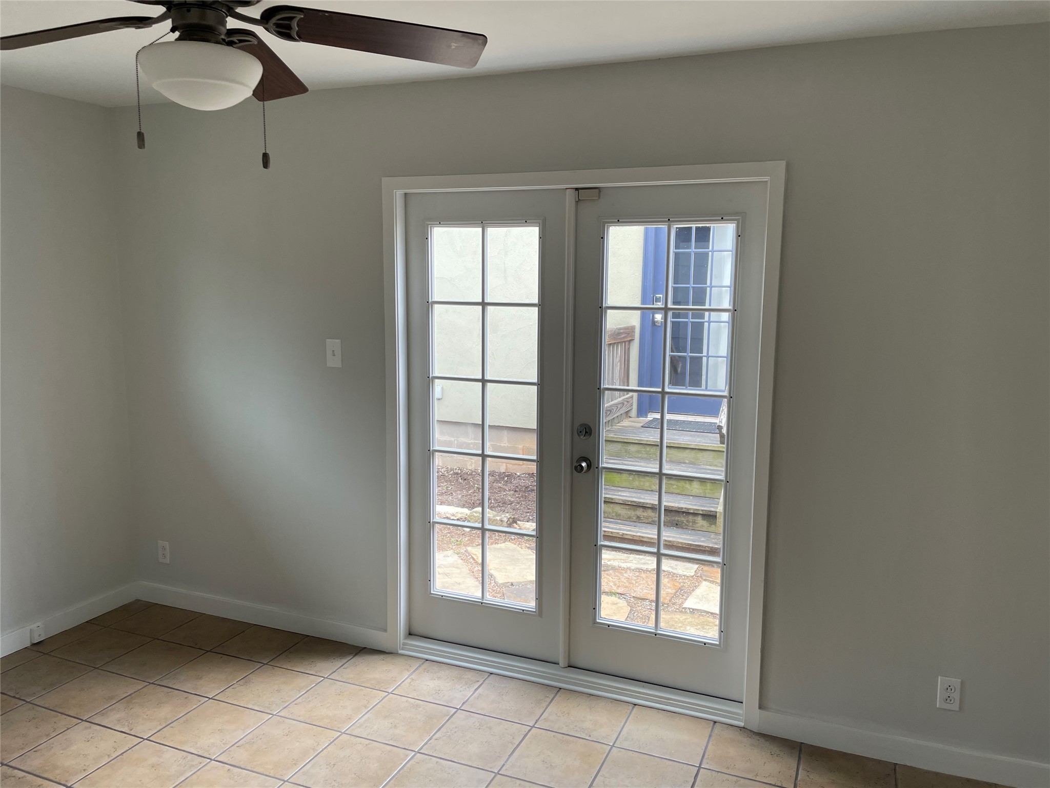 4619 Jinx Avenue, Unit A Austin, TX 78745 - Photo 9 of 21 Room featuring light gray painted walls, a ceiling fan with light fixture, and ceramic tile flooring