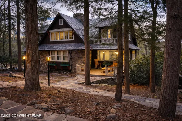 an outdoor sitting area with couch and wooden fence