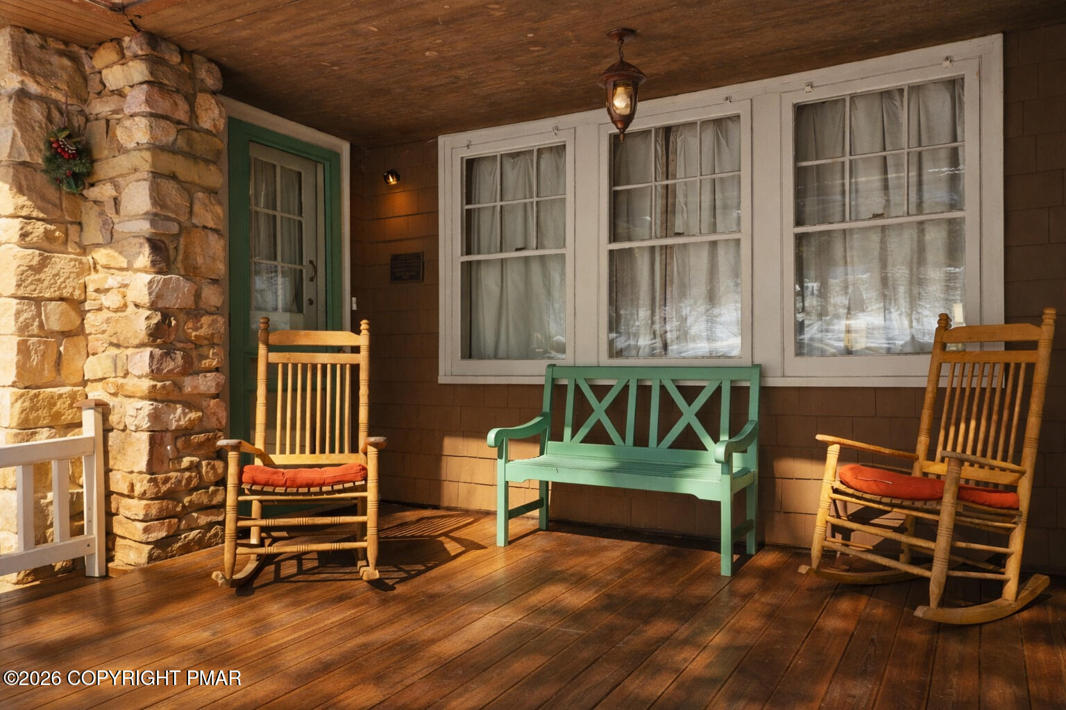 204 Lake Road Swiftwater, PA 18370 - Photo 3 of 76 an outdoor sitting area with couch and wooden fence