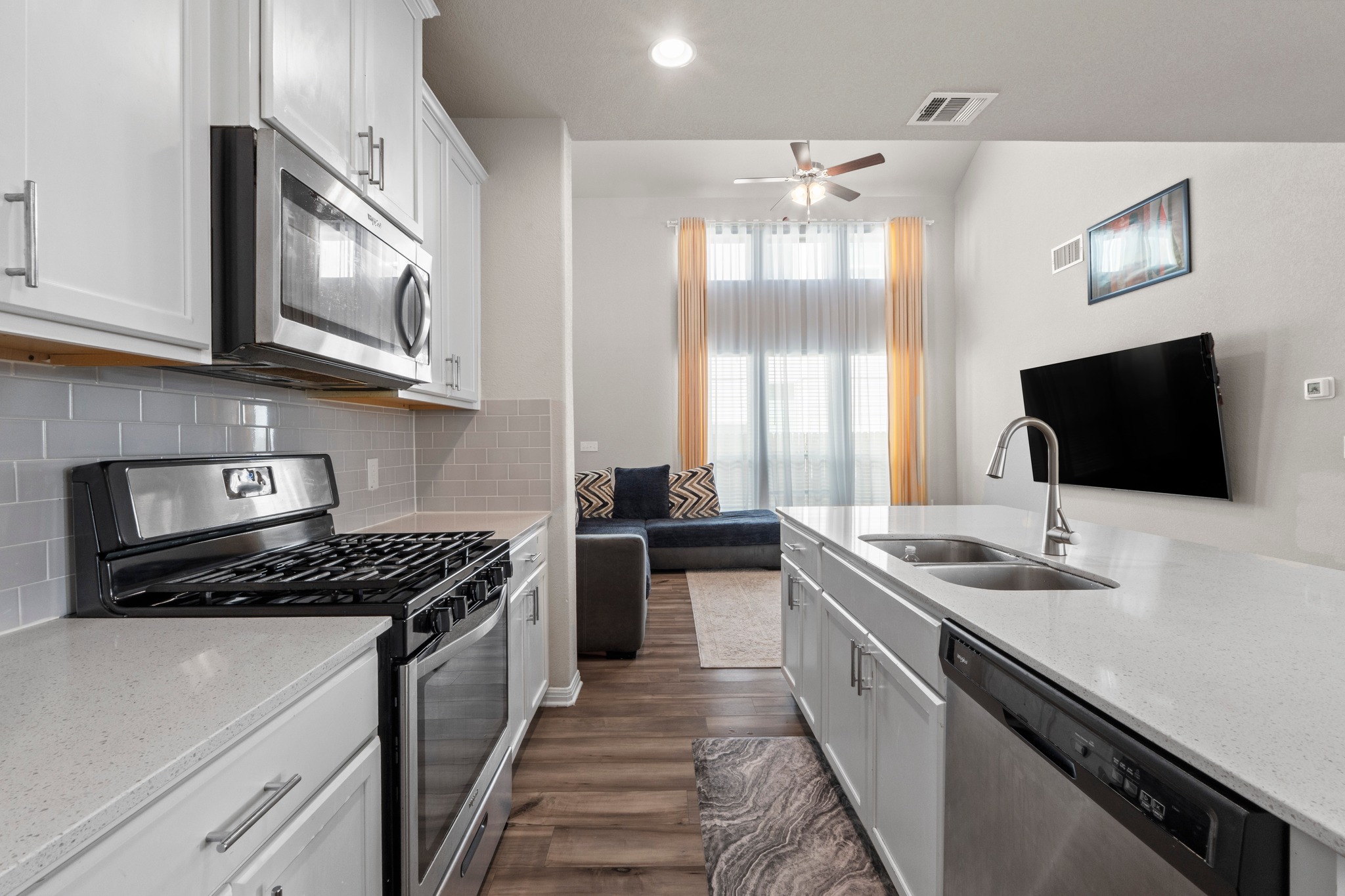 159 MacArthur Drive Leander, TX 78641 - Photo 10 of 31 a kitchen with stainless steel appliances a stove a sink and a microwave