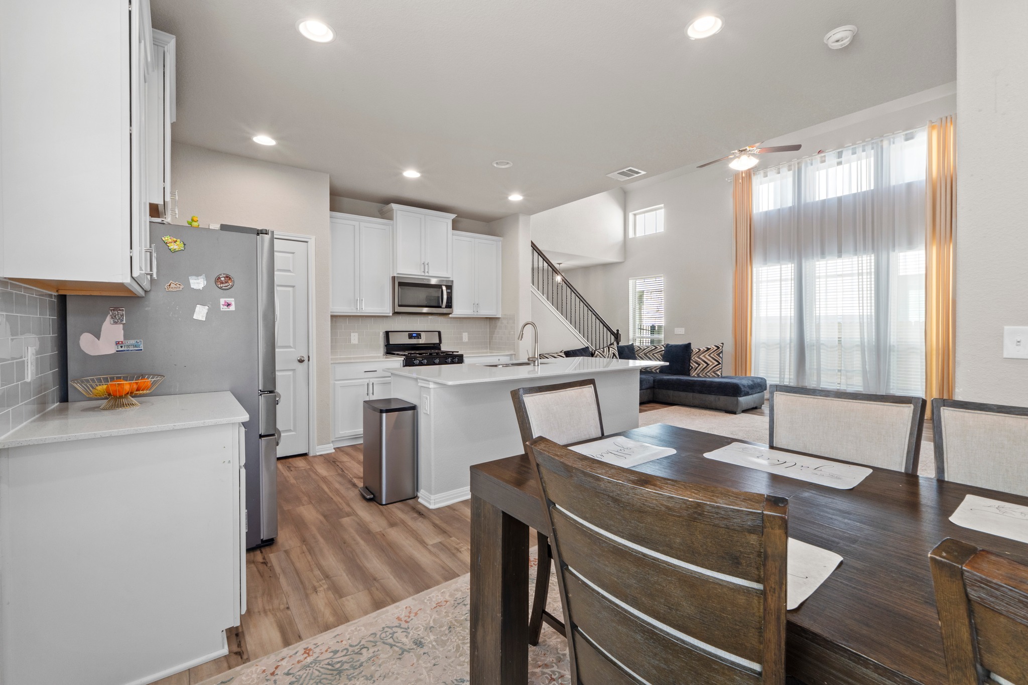 159 MacArthur Drive Leander, TX 78641 - Photo 13 of 31 a kitchen with kitchen island cabinets and wooden floor