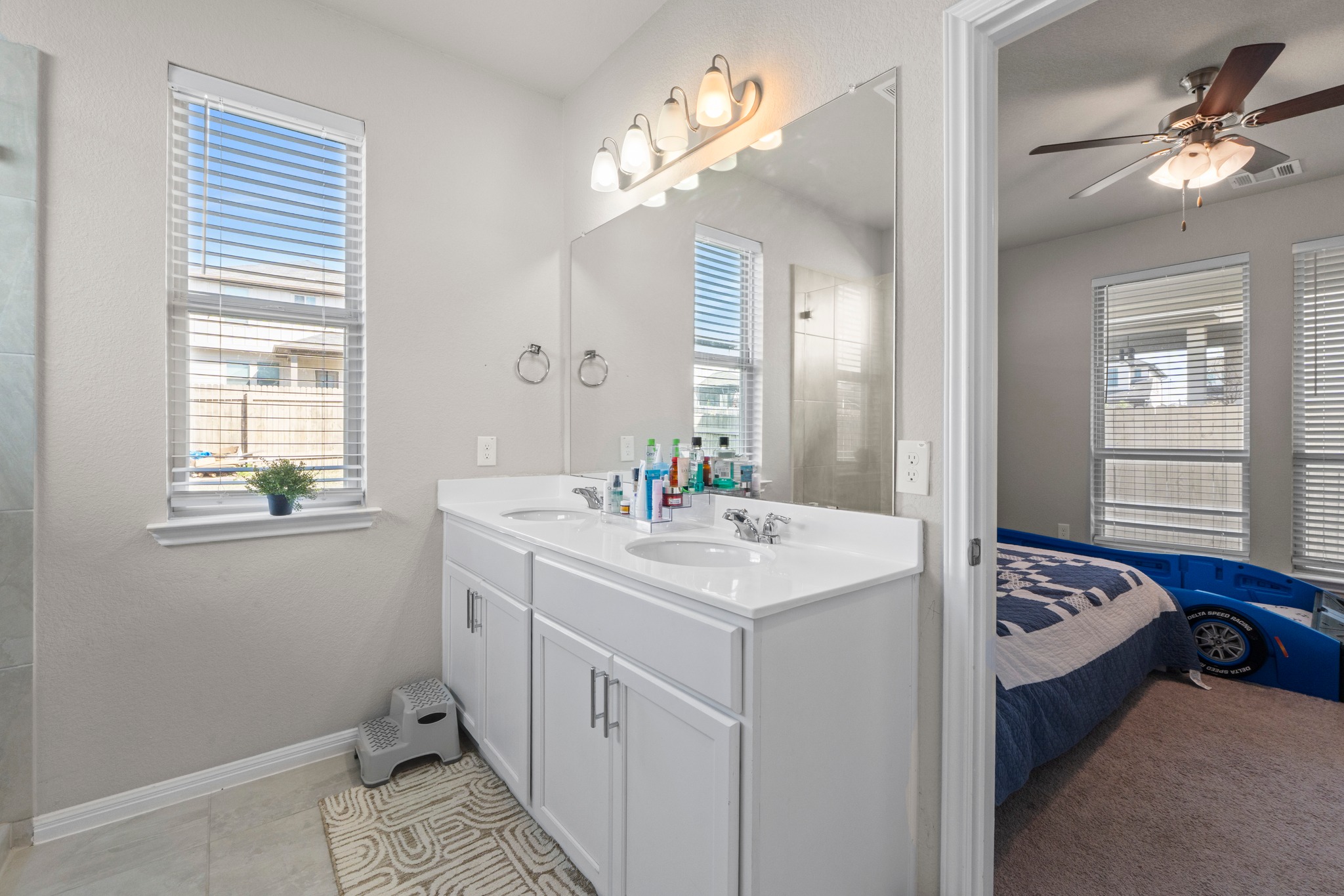 159 MacArthur Drive Leander, TX 78641 - Photo 17 of 31 a en suite bathroom with a sink double vanity and a mirror