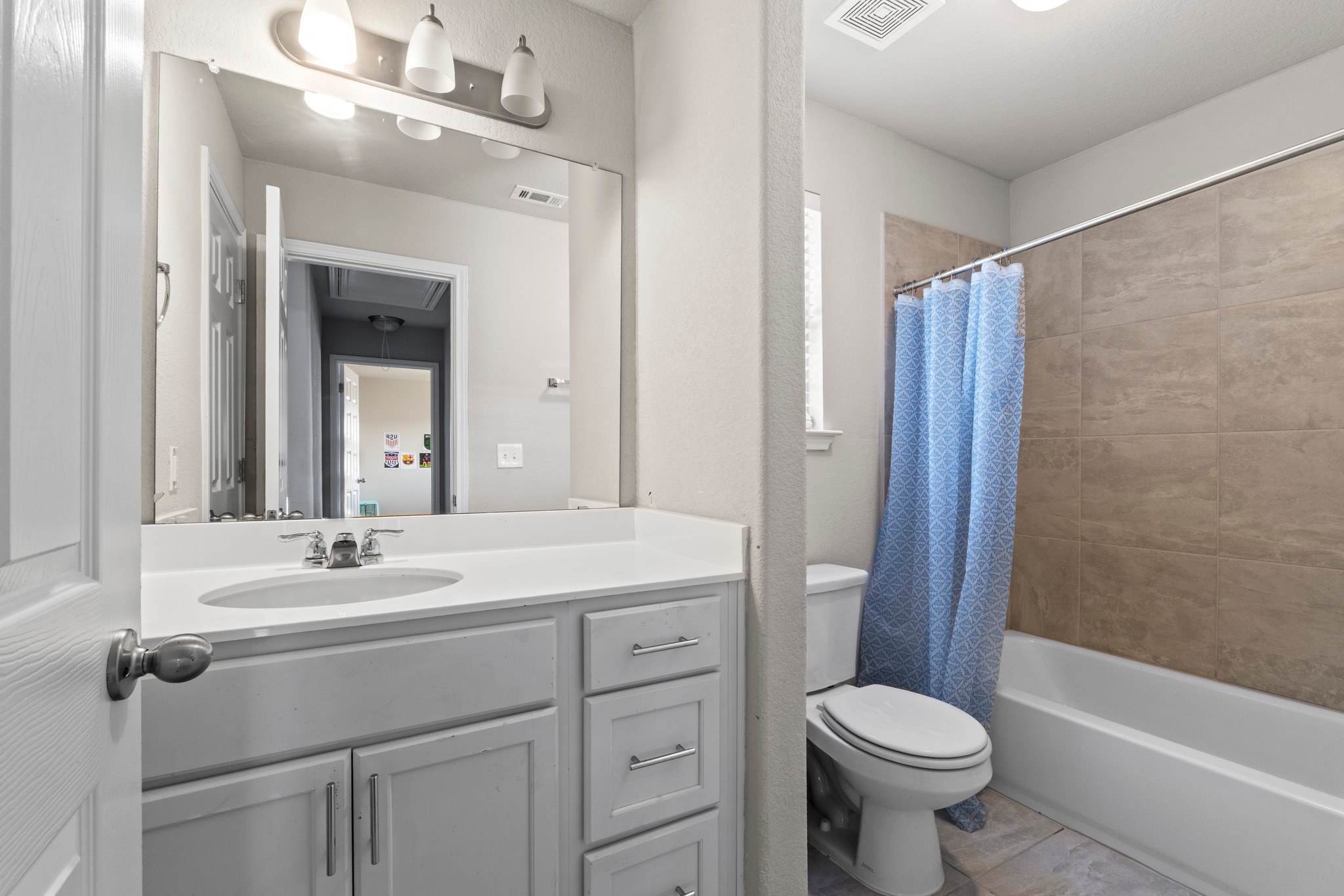 159 MacArthur Drive Leander, TX 78641 - Photo 26 of 31 a bathroom with a sink toilet a mirror and shower
