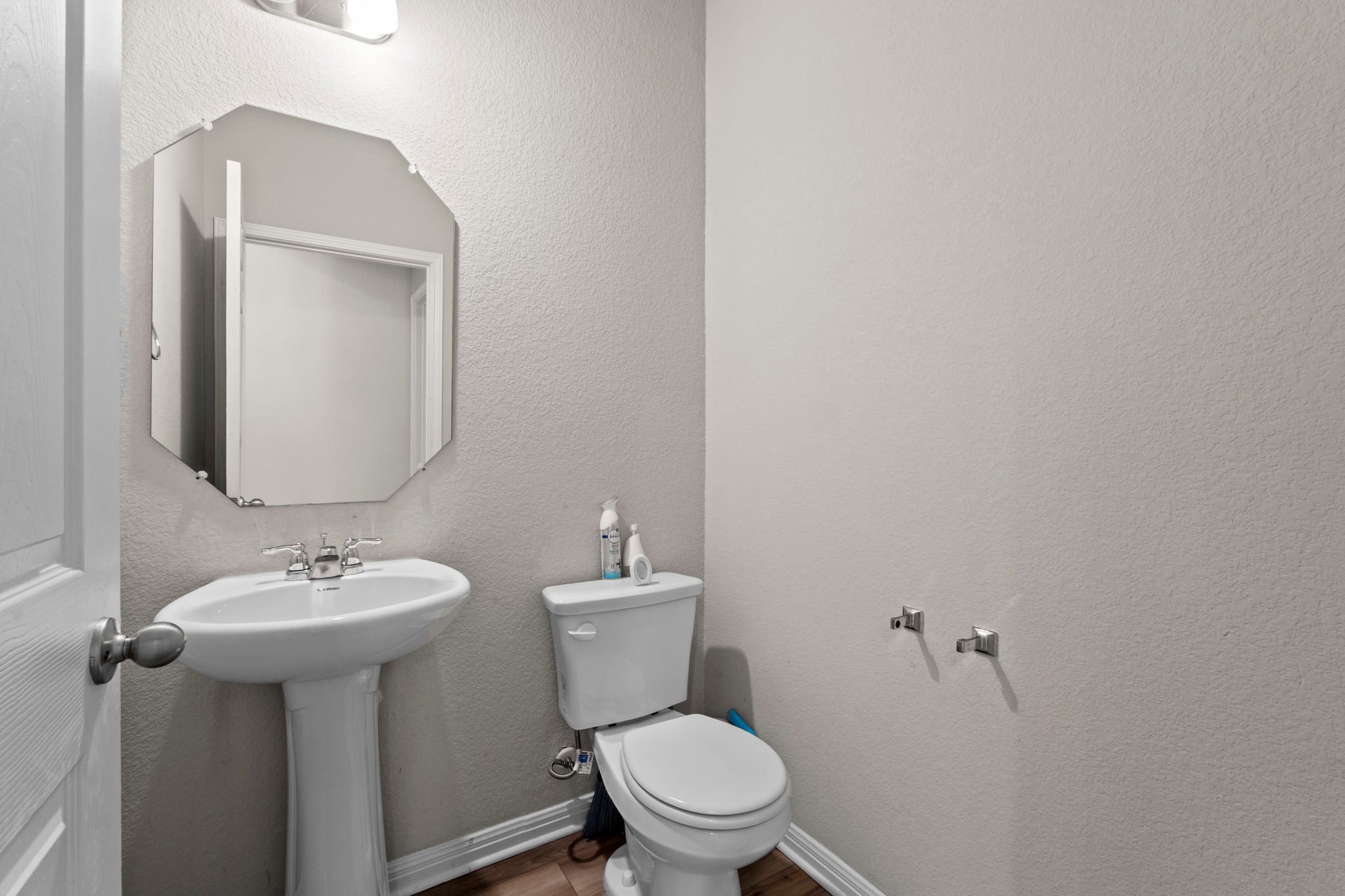 159 MacArthur Drive Leander, TX 78641 - Photo 27 of 31 a white toilet sitting next to a bathroom sink
