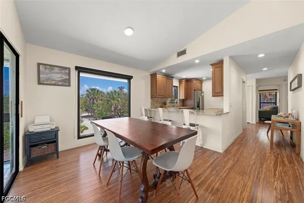 a dining room with furniture and wooden floor