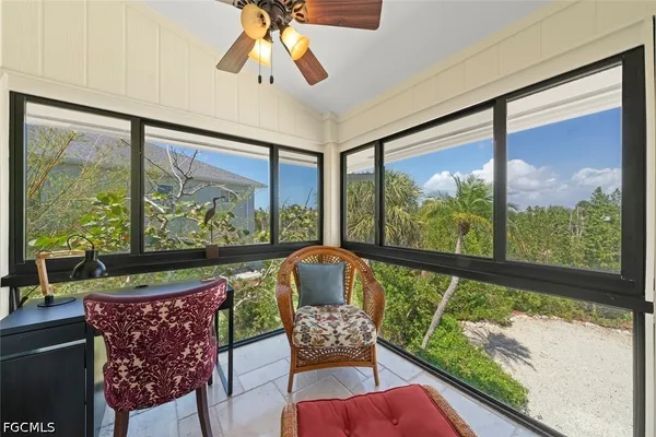a outdoor living room with furniture and a large window