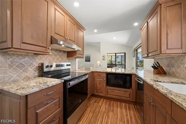 a kitchen with granite countertop stainless steel appliances and sink