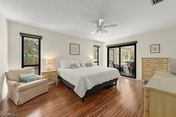 a spacious bedroom with a bed couch and a window