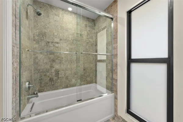 a bathroom with a bathtub and a shower