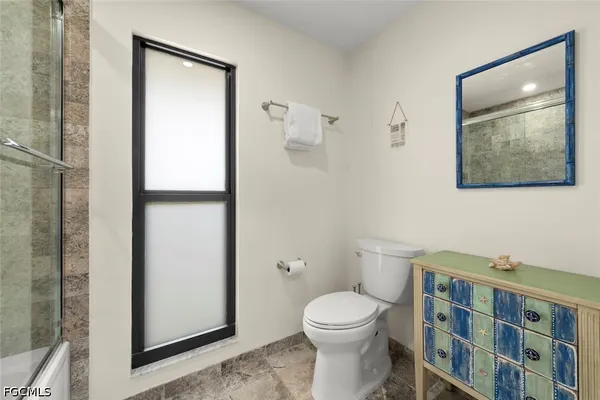 a bathroom with a toilet a sink and shower