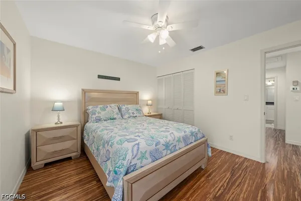 a bedroom with a bed and a ceiling fan