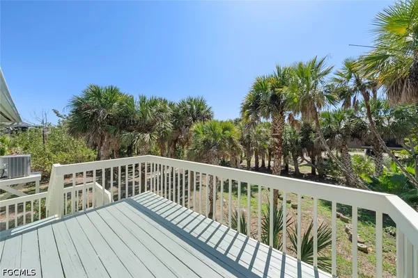 a view of balcony with wooden floor and fence