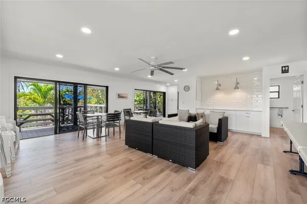 a living room with furniture and large wooden floor