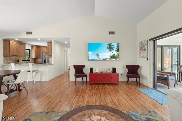 a living room with furniture and kitchen view
