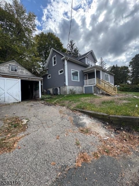 382 Howard Boulevard Mount Arlington, NJ 07856 - Photo 4 of 23 a front view of a house with a yard and garage