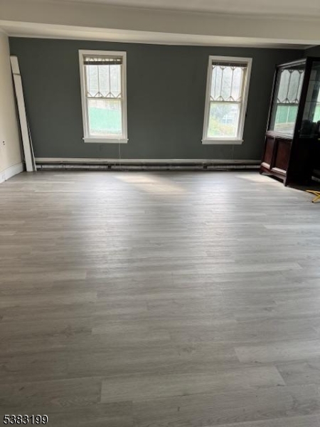382 Howard Boulevard Mount Arlington, NJ 07856 - Photo 8 of 23 a view of an empty room with wooden floor and a window