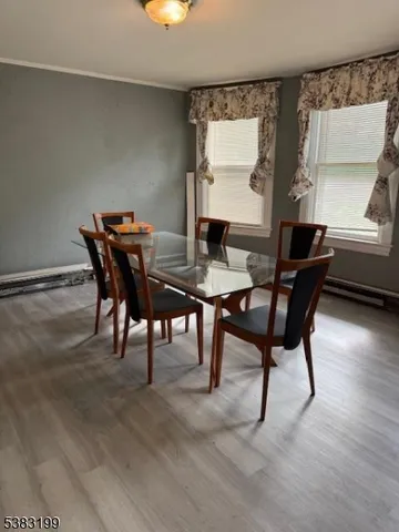 a view of a dining room with furniture and window