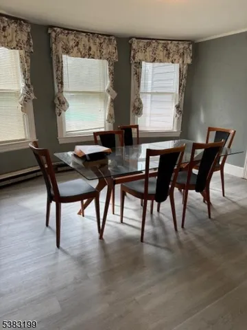 a view of a dining room with furniture and window