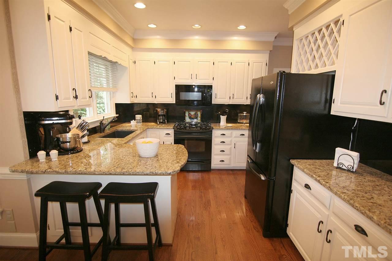 7903 Laurel Mountain Road Raleigh, NC 27613 - Photo 12 of 25 Kitchen Designed for Food and Fun Together -- complete with Eat-at Bar, Granite Countertops and Walk-in Pantry.